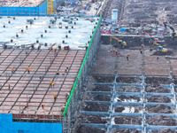 Workers speed up the construction of basic works at the construction site of the urban village renovation project in Chongqing, China, on No...