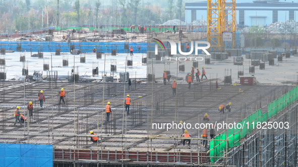 Workers speed up the construction of basic works at the construction site of the urban village renovation project in Chongqing, China, on No...