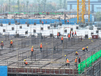 Workers speed up the construction of basic works at the construction site of the urban village renovation project in Chongqing, China, on No...