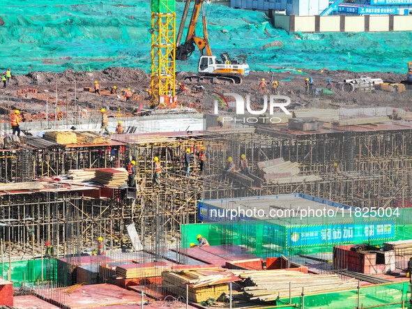 Workers speed up the construction of basic works at the construction site of the urban village renovation project in Chongqing, China, on No...