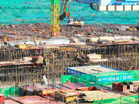 Workers speed up the construction of basic works at the construction site of the urban village renovation project in Chongqing, China, on No...