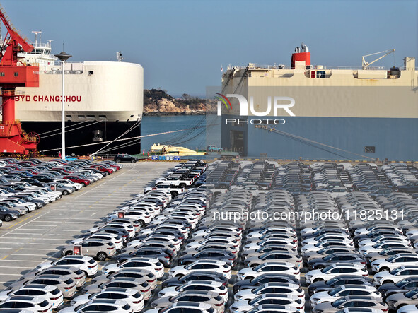 Roll-on wheels load export cars at the Lianyungang port in Lianyungang, Jiangsu province, China, on December 1, 2024. 