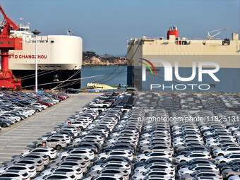 Roll-on wheels load export cars at the Lianyungang port in Lianyungang, Jiangsu province, China, on December 1, 2024. (