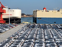 Roll-on wheels load export cars at the Lianyungang port in Lianyungang, Jiangsu province, China, on December 1, 2024. (