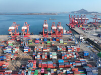 Cargo ships dock at the Lianyungang packing terminal to load and unload containers in Lianyungang, China, on December 1, 2024. (