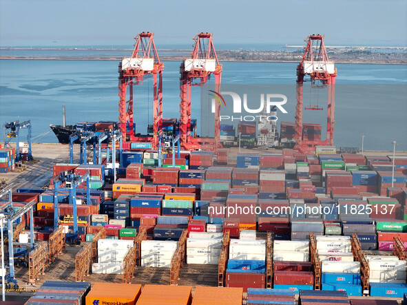 Cargo ships dock at the Lianyungang packing terminal to load and unload containers in Lianyungang, China, on December 1, 2024. 