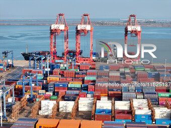 Cargo ships dock at the Lianyungang packing terminal to load and unload containers in Lianyungang, China, on December 1, 2024. (