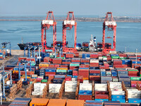 Cargo ships dock at the Lianyungang packing terminal to load and unload containers in Lianyungang, China, on December 1, 2024. (