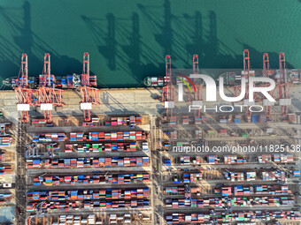 Cargo ships dock at the Lianyungang packing terminal to load and unload containers in Lianyungang, China, on December 1, 2024. (