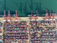 Cargo ships dock at the Lianyungang packing terminal to load and unload containers in Lianyungang, China, on December 1, 2024. (