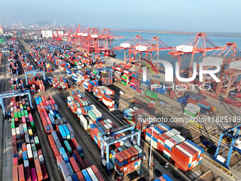 Cargo ships dock at the Lianyungang packing terminal to load and unload containers in Lianyungang, China, on December 1, 2024. (