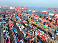 Cargo ships dock at the Lianyungang packing terminal to load and unload containers in Lianyungang, China, on December 1, 2024. (