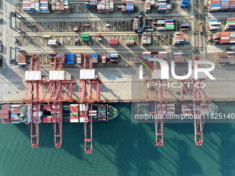 Cargo ships dock at the Lianyungang packing terminal to load and unload containers in Lianyungang, China, on December 1, 2024. (