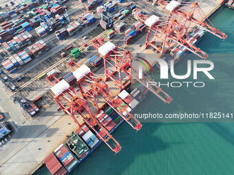 Cargo ships dock at the Lianyungang packing terminal to load and unload containers in Lianyungang, China, on December 1, 2024. (