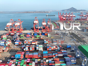 Cargo ships dock at the Lianyungang packing terminal to load and unload containers in Lianyungang, China, on December 1, 2024. (