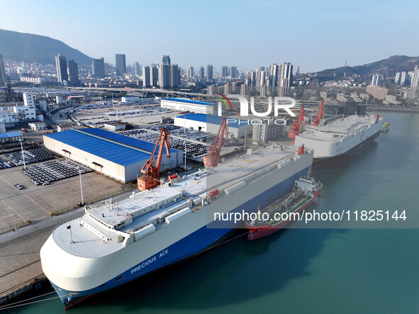 Roll-on wheels load export cars at the Lianyungang port in Lianyungang, Jiangsu province, China, on December 1, 2024. 