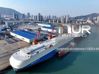 Roll-on wheels load export cars at the Lianyungang port in Lianyungang, Jiangsu province, China, on December 1, 2024. (