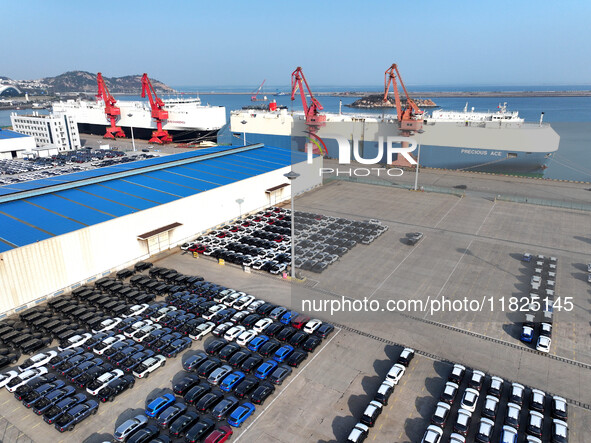 Roll-on wheels load export cars at the Lianyungang port in Lianyungang, Jiangsu province, China, on December 1, 2024. 