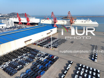 Roll-on wheels load export cars at the Lianyungang port in Lianyungang, Jiangsu province, China, on December 1, 2024. (