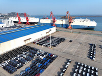 Roll-on wheels load export cars at the Lianyungang port in Lianyungang, Jiangsu province, China, on December 1, 2024. (