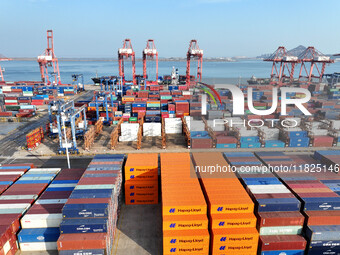 Cargo ships dock at the Lianyungang packing terminal to load and unload containers in Lianyungang, China, on December 1, 2024. (