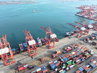 Cargo ships dock at the Lianyungang packing terminal to load and unload containers in Lianyungang, China, on December 1, 2024. (