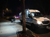 NYPD crime scene investigators search for evidence at the scene where a 30-year-old man is killed in an assault in the Throggs Neck section...