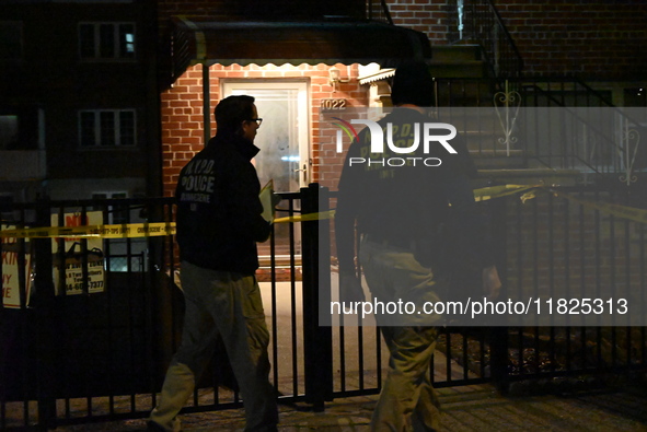 NYPD crime scene investigators search for evidence at the scene where a 30-year-old man is killed in an assault in the Throggs Neck section...