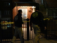 NYPD crime scene investigators search for evidence at the scene where a 30-year-old man is killed in an assault in the Throggs Neck section...