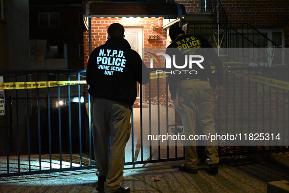 NYPD crime scene investigators search for evidence at the scene where a 30-year-old man is killed in an assault in the Throggs Neck section...