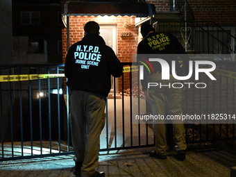 NYPD crime scene investigators search for evidence at the scene where a 30-year-old man is killed in an assault in the Throggs Neck section...