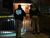 NYPD crime scene investigators search for evidence at the scene where a 30-year-old man is killed in an assault in the Throggs Neck section...