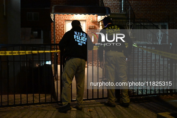 NYPD crime scene investigators search for evidence at the scene where a 30-year-old man is killed in an assault in the Throggs Neck section...