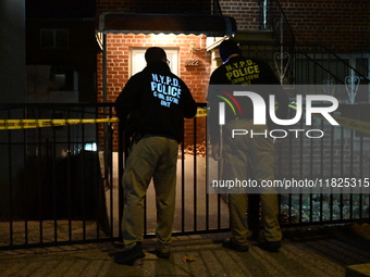 NYPD crime scene investigators search for evidence at the scene where a 30-year-old man is killed in an assault in the Throggs Neck section...