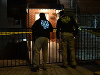 NYPD crime scene investigators search for evidence at the scene where a 30-year-old man is killed in an assault in the Throggs Neck section...