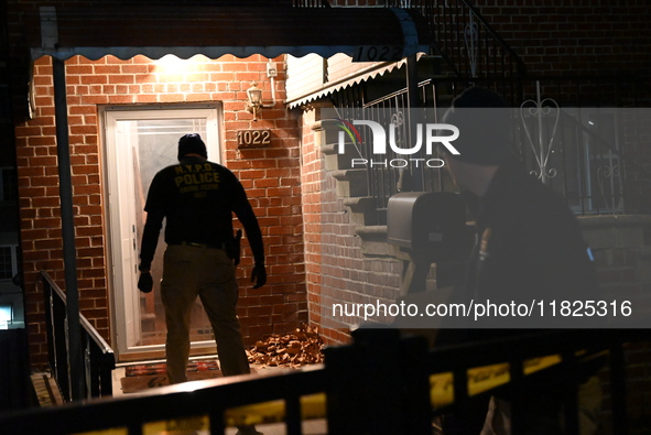 NYPD crime scene investigators search for evidence at the scene where a 30-year-old man is killed in an assault in the Throggs Neck section...