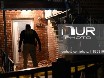 NYPD crime scene investigators search for evidence at the scene where a 30-year-old man is killed in an assault in the Throggs Neck section...