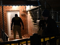 NYPD crime scene investigators search for evidence at the scene where a 30-year-old man is killed in an assault in the Throggs Neck section...