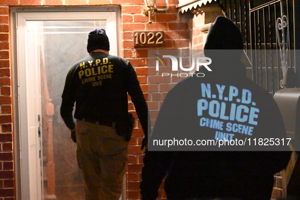 NYPD crime scene investigators search for evidence at the scene where a 30-year-old man is killed in an assault in the Throggs Neck section...