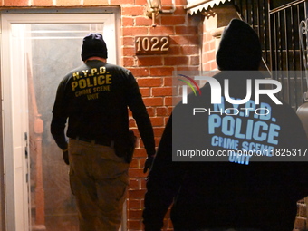 NYPD crime scene investigators search for evidence at the scene where a 30-year-old man is killed in an assault in the Throggs Neck section...