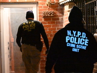 NYPD crime scene investigators search for evidence at the scene where a 30-year-old man is killed in an assault in the Throggs Neck section...