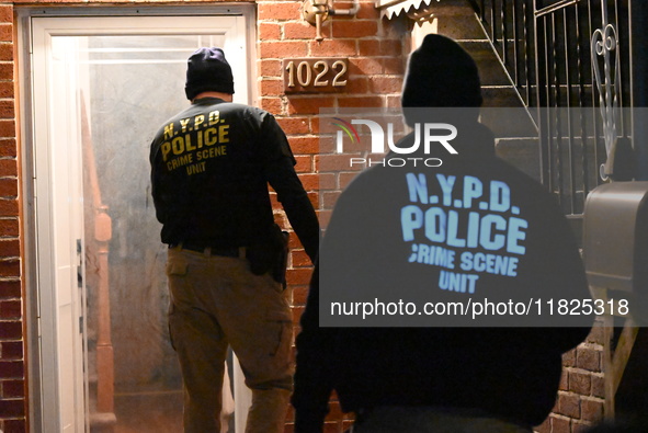 NYPD crime scene investigators search for evidence at the scene where a 30-year-old man is killed in an assault in the Throggs Neck section...