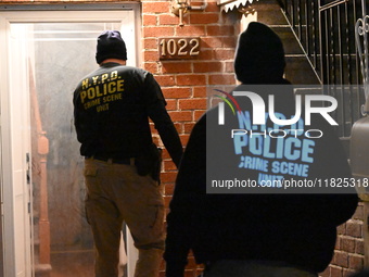 NYPD crime scene investigators search for evidence at the scene where a 30-year-old man is killed in an assault in the Throggs Neck section...