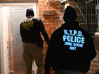 NYPD crime scene investigators search for evidence at the scene where a 30-year-old man is killed in an assault in the Throggs Neck section...