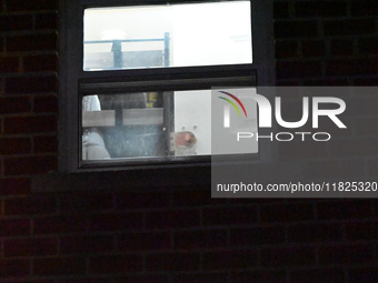 NYPD crime scene investigators search for evidence at the scene where a 30-year-old man is killed in an assault in the Throggs Neck section...