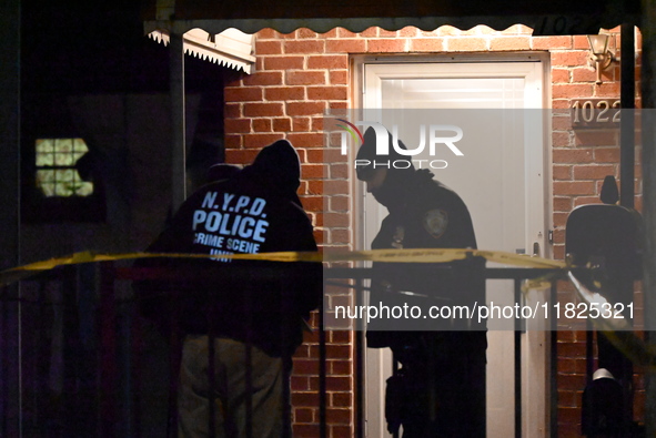 NYPD crime scene investigators search for evidence at the scene where a 30-year-old man is killed in an assault in the Throggs Neck section...