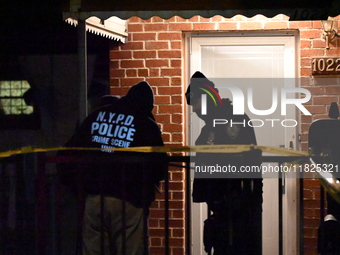 NYPD crime scene investigators search for evidence at the scene where a 30-year-old man is killed in an assault in the Throggs Neck section...