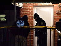 NYPD crime scene investigators search for evidence at the scene where a 30-year-old man is killed in an assault in the Throggs Neck section...