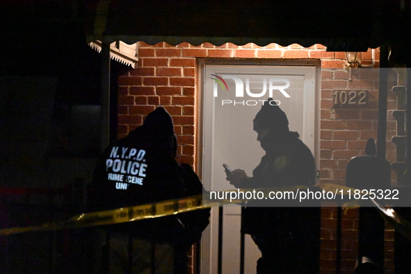 NYPD crime scene investigators search for evidence at the scene where a 30-year-old man is killed in an assault in the Throggs Neck section...