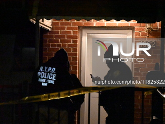 NYPD crime scene investigators search for evidence at the scene where a 30-year-old man is killed in an assault in the Throggs Neck section...